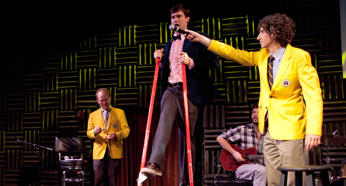 RecordSetter officials in yellow jackets judging a live record attempt on stilts